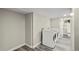 Bright Laundry room with washer, dryer, and access to the updated bathroom at 3636 Ames St, Wheat Ridge, CO 80212