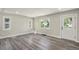 Bright living room with sleek grey flooring, fresh paint, and natural light from updated windows at 3636 Ames St, Wheat Ridge, CO 80212