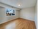 Bright bedroom with hardwood floors and large windows at 10825 Brewer Dr, Northglenn, CO 80234