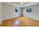 Bright bedroom with hardwood floors and two windows at 10825 Brewer Dr, Northglenn, CO 80234