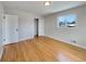 Well-lit bedroom featuring hardwood floors and a closet at 10825 Brewer Dr, Northglenn, CO 80234