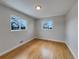 Light-filled bedroom, featuring hardwood floors and two windows at 10825 Brewer Dr, Northglenn, CO 80234