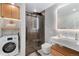 Modern bathroom featuring stylish vanity, large shower, and convenient washer/dryer combo at 720 Lipan St, Denver, CO 80204