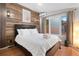 Cozy bedroom features a wood accent wall, modern lighting, and a comfortable bed with fresh white linens at 720 Lipan St, Denver, CO 80204