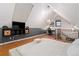 Unique bedroom with a vaulted ceiling also features a desk, TV, and hardwood floors for a modern and versatile space at 720 Lipan St, Denver, CO 80204