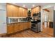 Well-lit kitchen featuring stainless steel appliances, wooden cabinets, and hardwood floors at 720 Lipan St, Denver, CO 80204