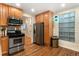 Functional kitchen with stainless steel appliances and wooden cabinetry at 720 Lipan St, Denver, CO 80204