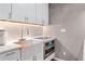 Modern kitchen features white cabinets, stainless steel oven, apron sink, and stylish countertops at 720 Lipan St, Denver, CO 80204