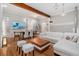 Open living room featuring hardwood floors, exposed beams, and bright natural lighting at 720 Lipan St, Denver, CO 80204