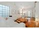 Bright living room boasts natural light, hardwood floors and modern white furniture at 720 Lipan St, Denver, CO 80204