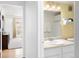 View from the bathroom to bedroom with walk-in shower and neutral wall paint at 6495 E Happy Canyon Rd # 114, Denver, CO 80237