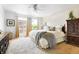 Bright bedroom features a ceiling fan, large windows, wood floors, and neutral colors at 6495 E Happy Canyon Rd # 114, Denver, CO 80237