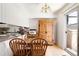 Bright dining area with a table, chairs, and natural light from sliding door at 6495 E Happy Canyon Rd # 114, Denver, CO 80237