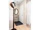 Home entryway with coat rack and black rug on light hardwood floors with neutral walls at 6495 E Happy Canyon Rd # 114, Denver, CO 80237