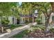 Charming condo exterior with brick accents, green landscaping, and inviting walkways at 6495 E Happy Canyon Rd # 114, Denver, CO 80237