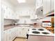 Well-lit kitchen featuring white cabinets and ample counter space for easy meal preparation at 6495 E Happy Canyon Rd # 114, Denver, CO 80237