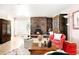 Cozy living room featuring a striking brick fireplace and comfortable seating arrangement at 6495 E Happy Canyon Rd # 114, Denver, CO 80237