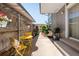 Cozy patio with yellow table and chairs, hanging plants, and a barbecue grill at 6495 E Happy Canyon Rd # 114, Denver, CO 80237