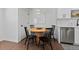 Cozy dining area with a round wooden table and four black chairs at 2785 S Linley Ct, Denver, CO 80236