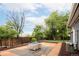 Backyard featuring a stone fire pit, lush lawn, and privacy fence at 7695 Quitman St, Westminster, CO 80030