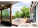 Landscaped backyard with fire pit, lush green lawn, and mature trees at 7695 Quitman St, Westminster, CO 80030