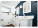Elegant bathroom features a dual sink vanity with modern fixtures and a wall accent at 7695 Quitman St, Westminster, CO 80030