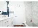 Contemporary bathroom boasts modern vanity and shower featuring hexagon tile detail for a luxurious touch at 7695 Quitman St, Westminster, CO 80030
