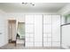 Bedroom features built-in closet system, wooden shelving unit and bright lighting at 7695 Quitman St, Westminster, CO 80030