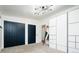 Bedroom with ample closet space, modern lighting, and cozy carpet flooring at 7695 Quitman St, Westminster, CO 80030