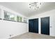 Bright bedroom featuring a modern closet, three windows, and a stylish lighting fixture at 7695 Quitman St, Westminster, CO 80030