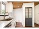 Updated kitchen features white cabinets, stainless steel appliances and fixtures, and wooden ceiling at 7695 Quitman St, Westminster, CO 80030