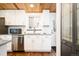 Renovated kitchen features stainless steel appliances, white cabinets, and modern backsplash at 7695 Quitman St, Westminster, CO 80030