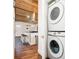 Kitchen showcases bar stool seating at the island, wooden ceiling, and stacked washer/dryer at 7695 Quitman St, Westminster, CO 80030
