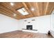 Bright living room featuring wood floors, a modern fireplace, and a unique wood ceiling with a skylight at 7695 Quitman St, Westminster, CO 80030