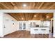 Spacious living room with a modern kitchen, white walls, wood floors, and a stunning wood ceiling with recessed lighting at 7695 Quitman St, Westminster, CO 80030
