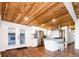 Inviting living space featuring a modern kitchen, stylish wood floors, and a unique wood ceiling with recessed lighting at 7695 Quitman St, Westminster, CO 80030