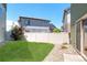 Lawn backyard with a privacy fence, stone bed, and patio area at 19120 E 54Th Pl, Denver, CO 80249