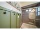 Bathroom featuring stylish green panelling, a modern shower, and elegant fixtures at 19120 E 54Th Pl, Denver, CO 80249