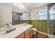 Bright bathroom boasts a single vanity, modern lighting, and walk-in shower perfect for relaxation at 19120 E 54Th Pl, Denver, CO 80249