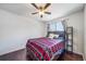 Bright bedroom featuring hardwood floors, a ceiling fan, and a comfortable bed at 19120 E 54Th Pl, Denver, CO 80249