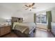 Cozy bedroom features a wooden bed, window, and ceiling fan providing an inviting space at 19120 E 54Th Pl, Denver, CO 80249