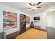 Bonus room features modern artwork, hardwood floors, and comfortable seating with plenty of natural light at 19120 E 54Th Pl, Denver, CO 80249