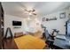 Bright bonus room features hardwood floors, a ceiling fan, and a desk area perfect for work or hobbies at 19120 E 54Th Pl, Denver, CO 80249