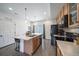 Bright kitchen with island, modern appliances, light wood cabinets and wood-look floors at 19120 E 54Th Pl, Denver, CO 80249