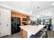 Open kitchen with island, barstool seating, and stainless-steel appliances at 19120 E 54Th Pl, Denver, CO 80249