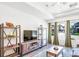 Living room with wood floors, tray ceiling, and neutral paint at 19120 E 54Th Pl, Denver, CO 80249