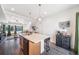 Open concept with island separating kitchen from living area, wood floors and neutral palette at 19120 E 54Th Pl, Denver, CO 80249