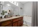 Bathroom boasts a modern vanity, full-sized mirror, bath tub and combination bath and shower at 13456 Via Varra # 401, Broomfield, CO 80020