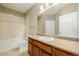 Bright bathroom featuring a vanity with light wood cabinets and a shower-tub combination with decorative tile accents at 13456 Via Varra # 401, Broomfield, CO 80020