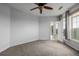Spacious bedroom featuring plush carpeting and ample natural light from the windows at 13456 Via Varra # 401, Broomfield, CO 80020